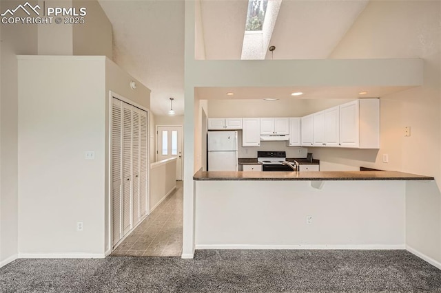kitchen featuring freestanding refrigerator, range with electric cooktop, under cabinet range hood, dark countertops, and carpet floors