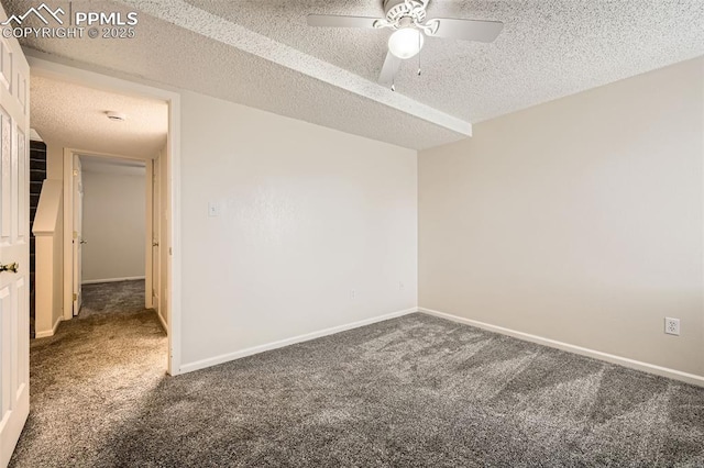 carpeted empty room with ceiling fan, a textured ceiling, and baseboards