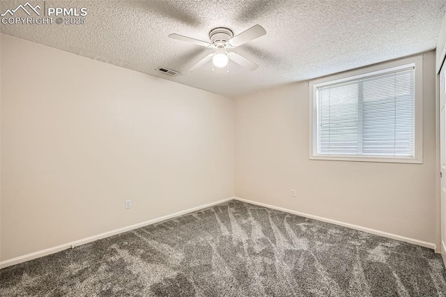 carpeted spare room featuring a textured ceiling, visible vents, baseboards, and a ceiling fan