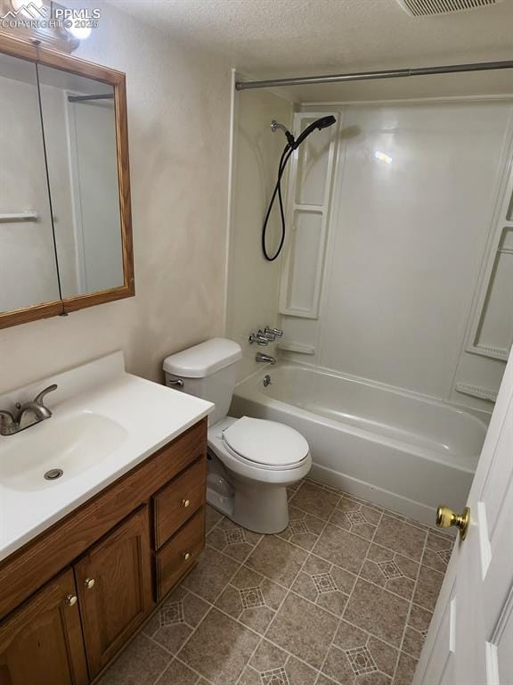 bathroom featuring toilet, vanity, visible vents, tile patterned flooring, and bathtub / shower combination