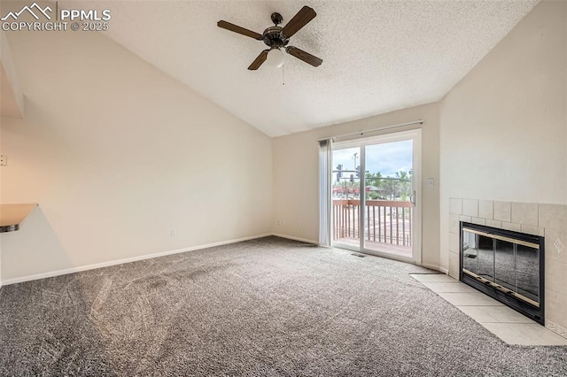 unfurnished living room featuring a tile fireplace, carpet, a textured ceiling, and ceiling fan