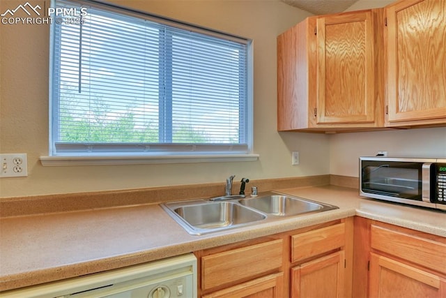 2610 Plumtree Grv, Colorado Springs, CO 80907 - kitchen featuring stainless steel microwave, white dishwasher, plenty of natural light, and a sink