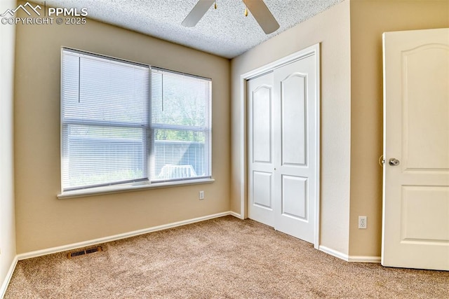 2610 Plumtree Grv, Colorado Springs, CO 80907 - unfurnished bedroom featuring carpet floors, a closet, a textured ceiling, baseboards, and a ceiling fan