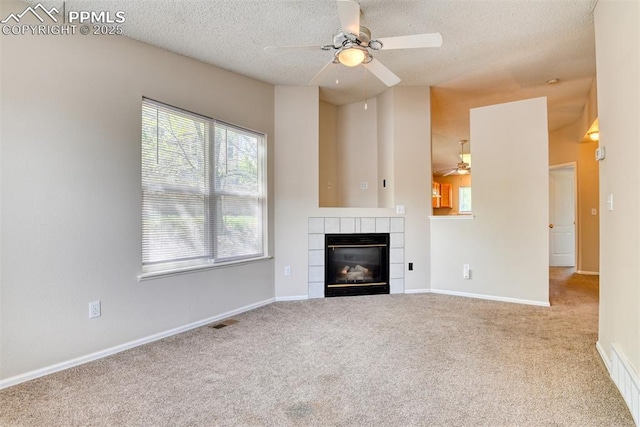2610 Plumtree Grv, Colorado Springs, CO 80907 - unfurnished living room with ceiling fan, carpet floors, a tiled fireplace, a textured ceiling, and baseboards