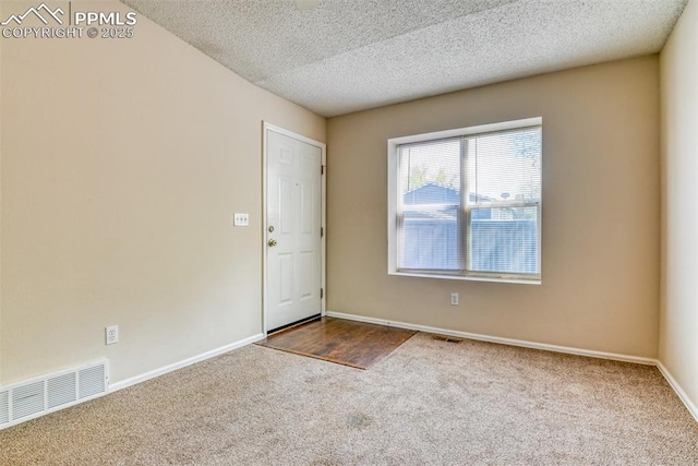 2610 Plumtree Grv, Colorado Springs, CO 80907 - carpeted empty room featuring a textured ceiling and baseboards