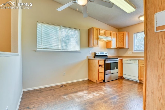 2610 Plumtree Grv, Colorado Springs, CO 80907 - kitchen with electric range, white dishwasher, under cabinet range hood, vaulted ceiling, and wood finished floors
