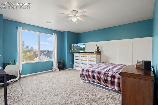 carpeted bedroom featuring baseboards and a ceiling fan