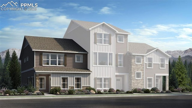 view of front of home featuring a mountain view, stone siding, and board and batten siding