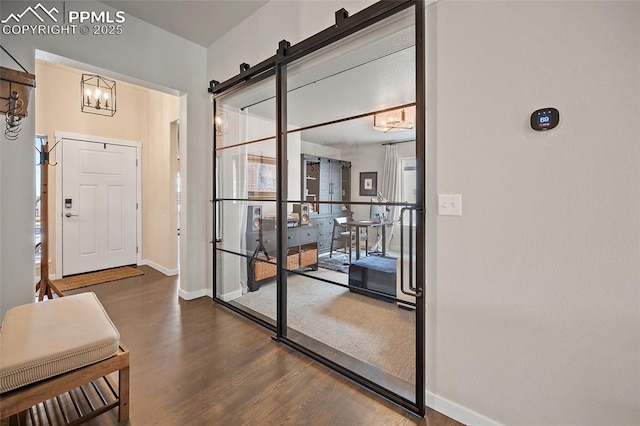 4932 Sand Canyon Trl, Colorado Springs, CO 80924 - entryway with wood finished floors, baseboards, and a chandelier