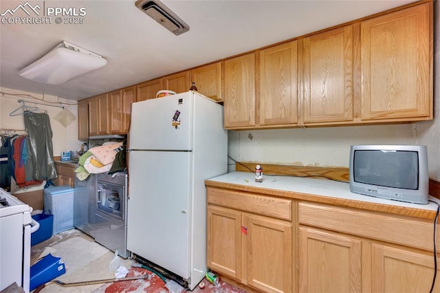1416 N Foote Ave, Colorado Springs, CO 80909 - kitchen featuring freestanding refrigerator, light countertops, range, and washer / clothes dryer