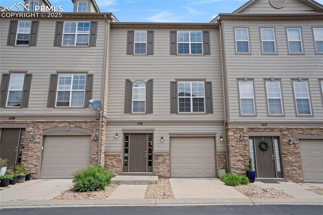 1118 Walters Pt, Monument, CO 80132 - view of property with a garage, driveway, and stone siding