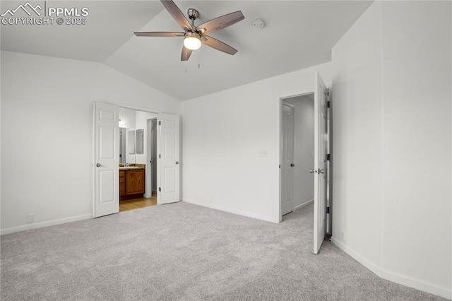 1118 Walters Pt, Monument, CO 80132 - unfurnished bedroom with light colored carpet, vaulted ceiling, connected bathroom, and a ceiling fan