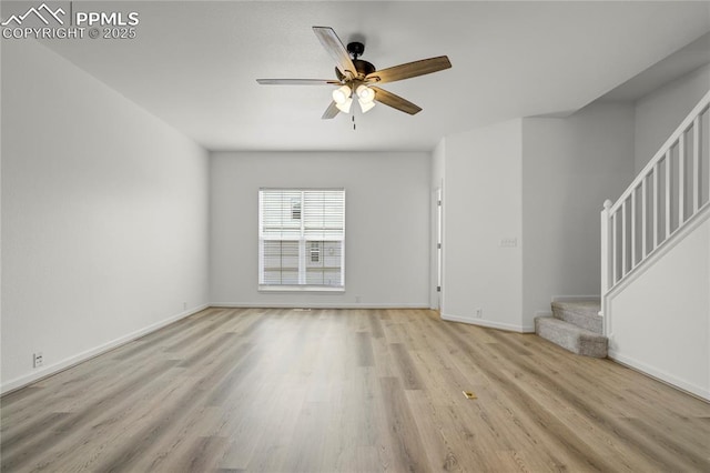 1118 Walters Pt, Monument, CO 80132 - unfurnished living room with light wood-type flooring, stairs, and a ceiling fan