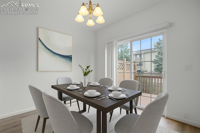 1118 Walters Pt, Monument, CO 80132 - dining area with a chandelier and wood finished floors
