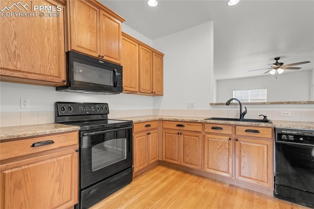 1118 Walters Pt, Monument, CO 80132 - kitchen with black appliances, ceiling fan, light wood finished floors, recessed lighting, and light stone counters