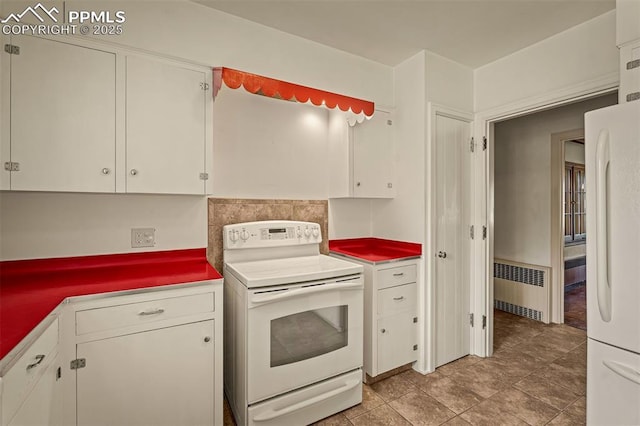 2126 Wood Ave, Colorado Springs, CO 80907 - kitchen featuring white appliances, radiator, white cabinetry, and light countertops