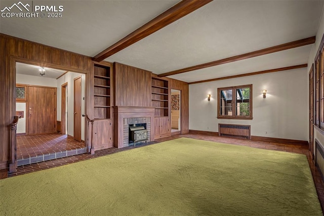 2126 Wood Ave, Colorado Springs, CO 80907 - unfurnished living room with radiator, carpet flooring, baseboards, beam ceiling, and a fireplace