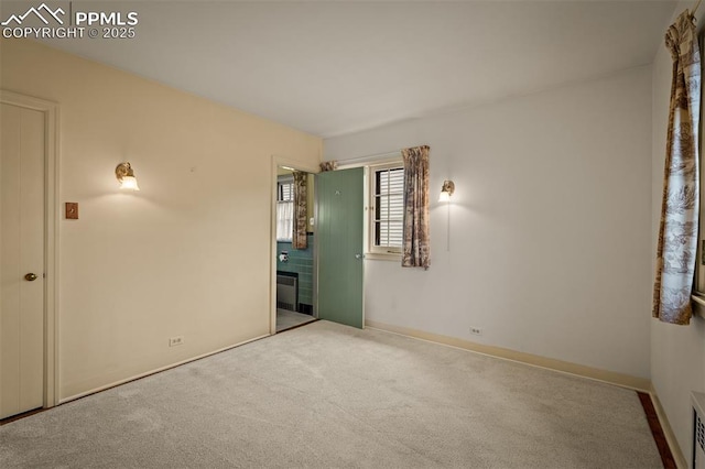 2126 Wood Ave, Colorado Springs, CO 80907 - carpeted empty room featuring radiator and baseboards