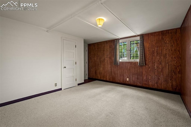 2126 Wood Ave, Colorado Springs, CO 80907 - unfurnished room with carpet floors, wood walls, and baseboards