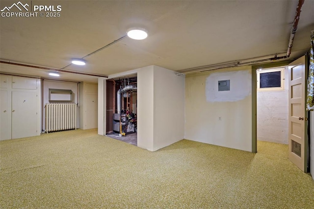 2126 Wood Ave, Colorado Springs, CO 80907 - finished basement with radiator heating unit, carpet flooring, and recessed lighting