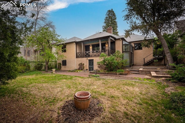 2126 Wood Ave, Colorado Springs, CO 80907 - back of property featuring a yard, stucco siding, stairway, and a chimney