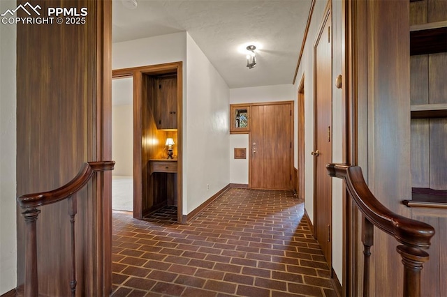 2126 Wood Ave, Colorado Springs, CO 80907 - hallway featuring brick floors and baseboards