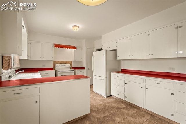 2126 Wood Ave, Colorado Springs, CO 80907 - kitchen with white appliances, a sink, white cabinetry, and a peninsula