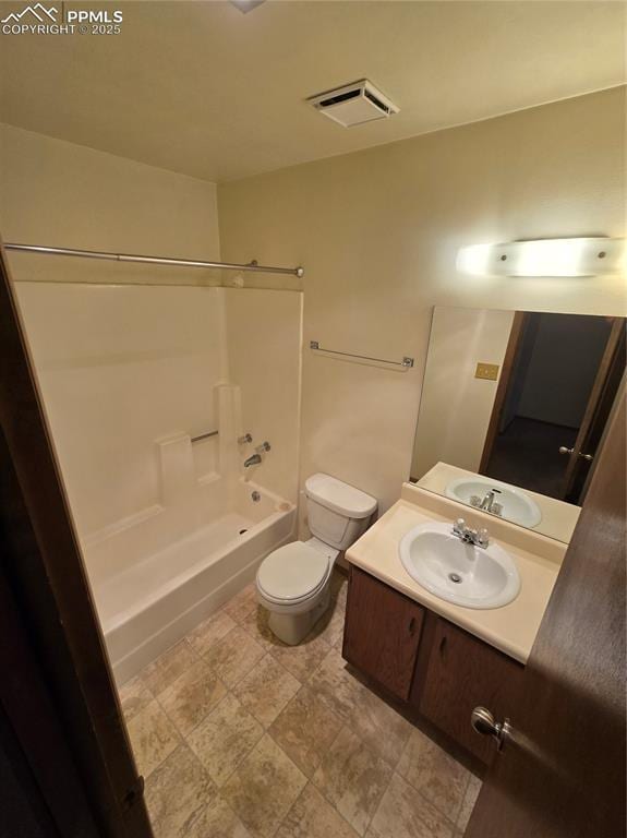 bathroom featuring toilet, vanity, visible vents, and shower / tub combination