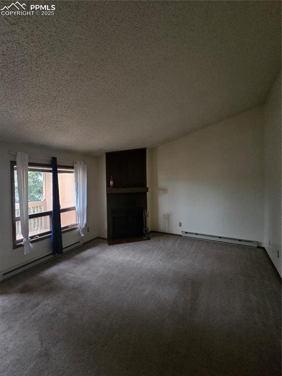 unfurnished living room with carpet flooring, a baseboard radiator, a fireplace, and a textured ceiling