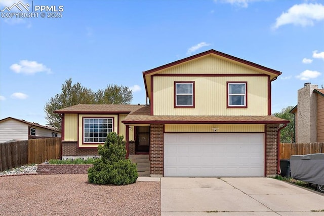 3425 Post Oak Dr, Colorado Springs, CO 80916 - tri-level home with fence, brick siding, concrete driveway, and a garage