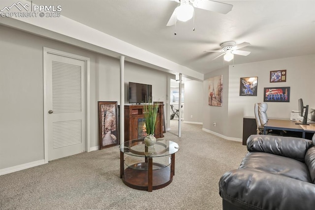 living area with carpet flooring, baseboards, and a ceiling fan