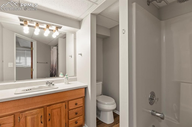 full bath featuring toilet, shower / tub combo with curtain, wood finished floors, and vanity