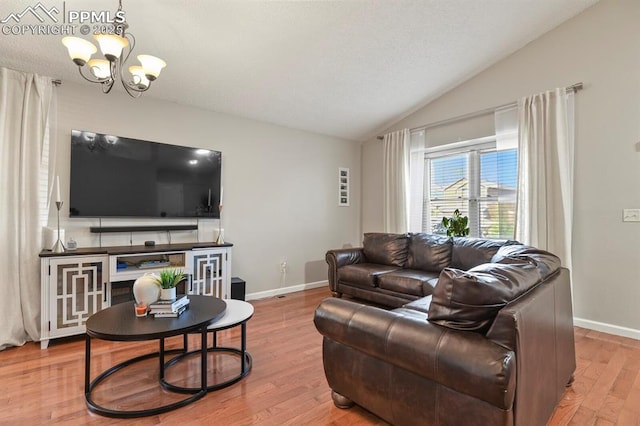 living area with an inviting chandelier, baseboards, light wood-style flooring, and lofted ceiling