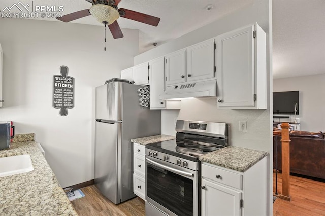 kitchen featuring under cabinet range hood, ceiling fan, light wood-style flooring, white cabinetry, and appliances with stainless steel finishes