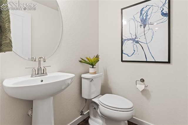 5131 Roundhouse Dr, Colorado Springs, CO 80925 - half bath featuring toilet and baseboards