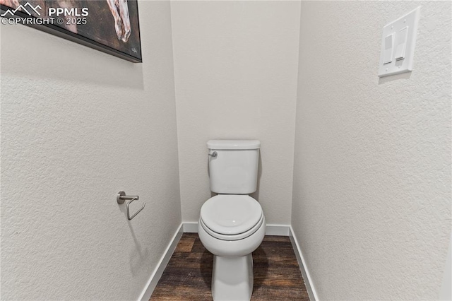 5131 Roundhouse Dr, Colorado Springs, CO 80925 - bathroom featuring toilet, a textured wall, baseboards, and wood finished floors
