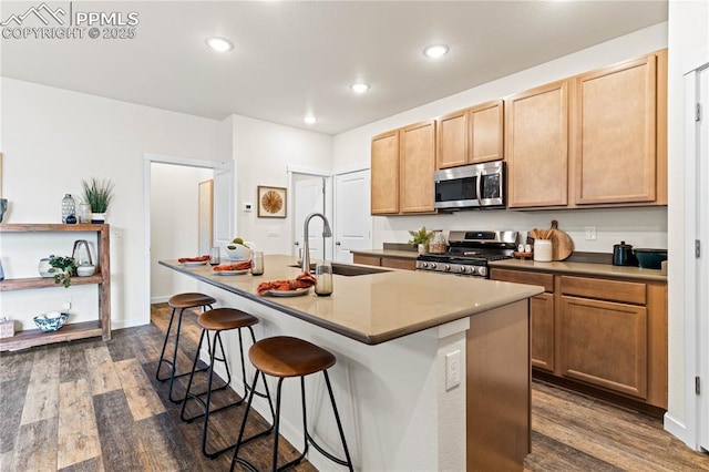 5131 Roundhouse Dr, Colorado Springs, CO 80925 - kitchen featuring recessed lighting, a kitchen breakfast bar, appliances with stainless steel finishes, and dark wood-style floors