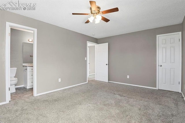 7920 Conifer Dr, Colorado Springs, CO 80920 - unfurnished bedroom featuring carpet, baseboards, ensuite bath, a textured ceiling, and a ceiling fan