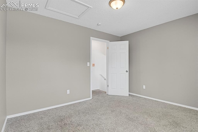 7920 Conifer Dr, Colorado Springs, CO 80920 - carpeted spare room featuring attic access, baseboards, and a textured ceiling