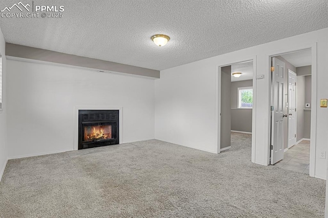 7920 Conifer Dr, Colorado Springs, CO 80920 - unfurnished living room featuring carpet floors, a textured ceiling, a fireplace with flush hearth, and baseboards