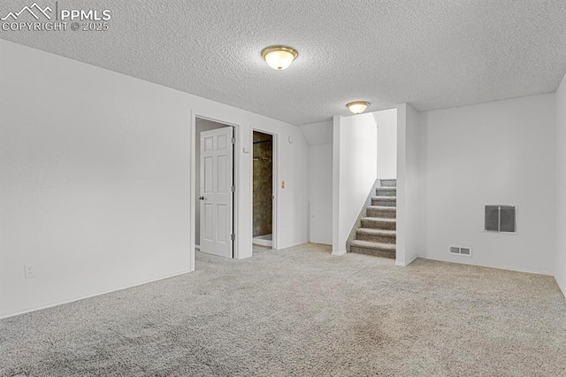 7920 Conifer Dr, Colorado Springs, CO 80920 - finished below grade area with stairs, carpet flooring, a textured ceiling, and baseboards