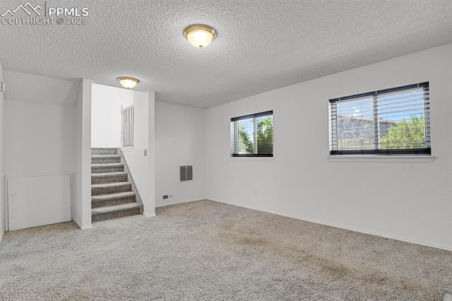 7920 Conifer Dr, Colorado Springs, CO 80920 - below grade area featuring stairway, carpet, and a textured ceiling