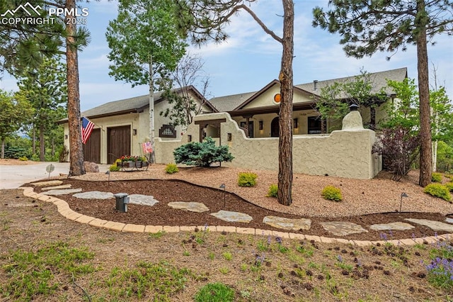 17995 Minglewood Trl, Monument, CO 80132 - view of front of home with an attached garage, concrete driveway, and stucco siding
