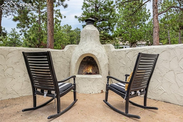 17995 Minglewood Trl, Monument, CO 80132 - view of patio with a lit fireplace