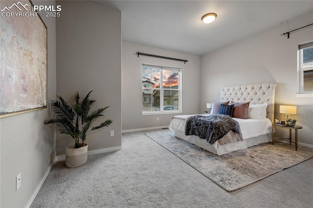 bedroom featuring carpet, baseboards, and multiple windows