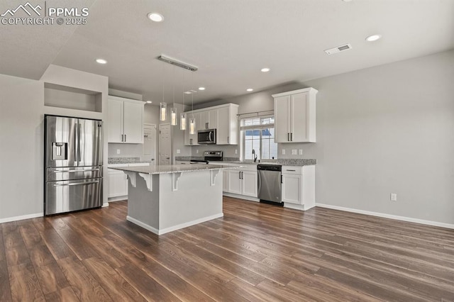 7238 Fauna Glen Dr, Colorado Springs, CO 80927 - kitchen featuring stainless steel appliances, dark wood finished floors, a breakfast bar area, white cabinetry, and recessed lighting