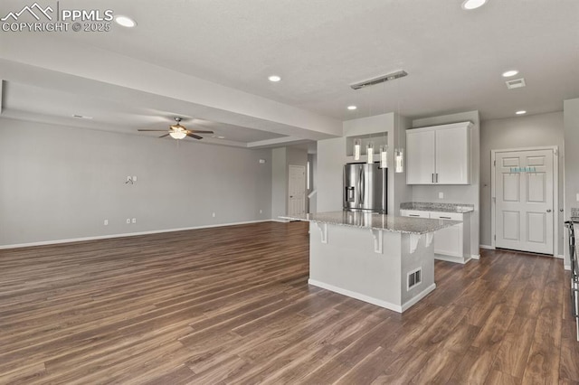 7238 Fauna Glen Dr, Colorado Springs, CO 80927 - kitchen with stainless steel fridge, recessed lighting, ceiling fan, dark wood-style flooring, and a breakfast bar area