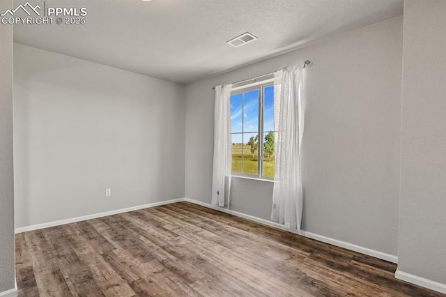 7238 Fauna Glen Dr, Colorado Springs, CO 80927 - spare room featuring wood finished floors and baseboards