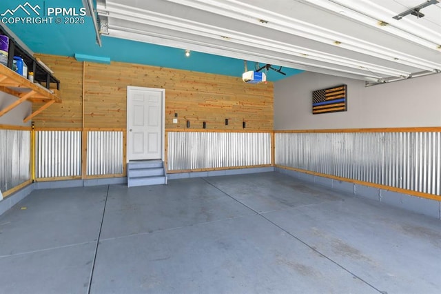 7238 Fauna Glen Dr, Colorado Springs, CO 80927 - garage with a garage door opener and wood walls
