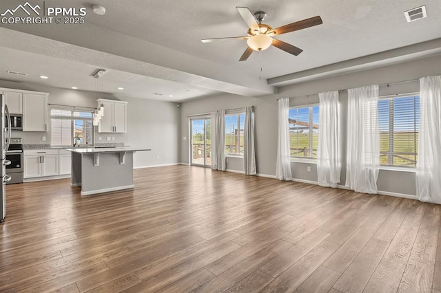 7238 Fauna Glen Dr, Colorado Springs, CO 80927 - unfurnished living room with ceiling fan, dark wood-style floors, recessed lighting, and a textured ceiling